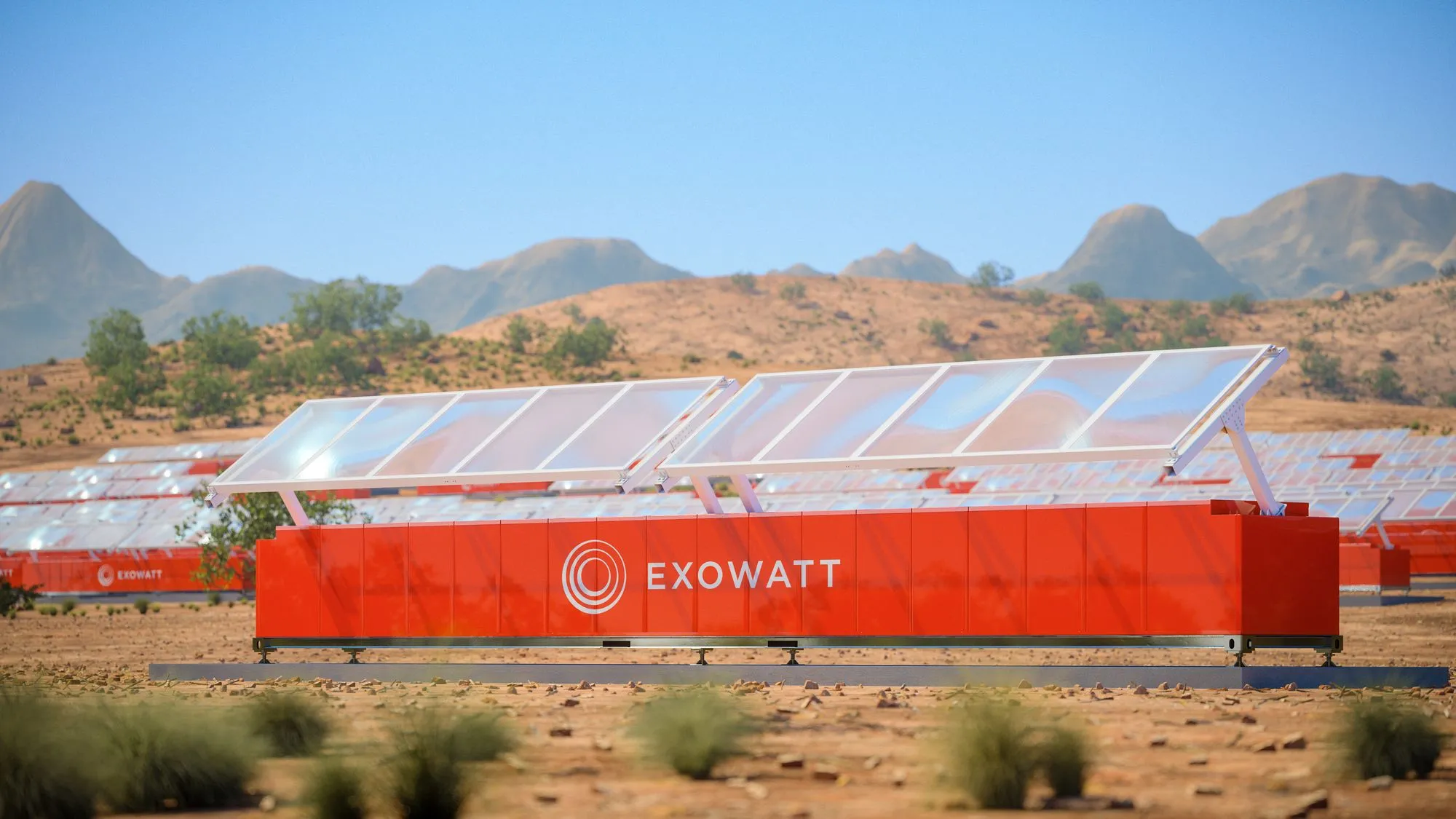 A 40-foot shipping container on open ground, its upper surface covered by an array of lens panels angled toward the sun.